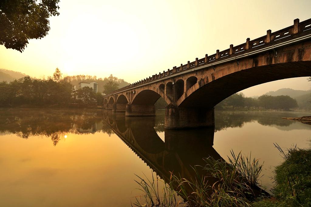Hands holding a smartphone with contact icon on screen
